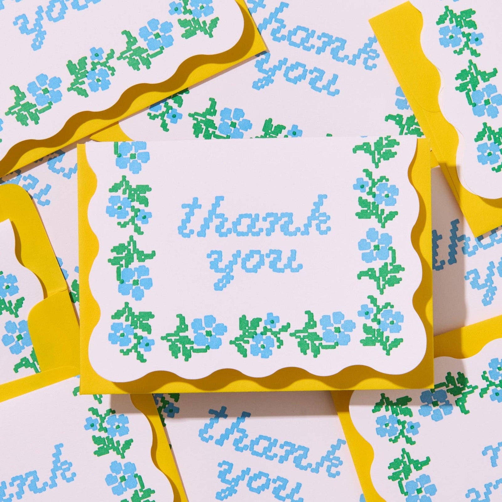 Set of 'thank you' cards with floral designs and yellow borders.