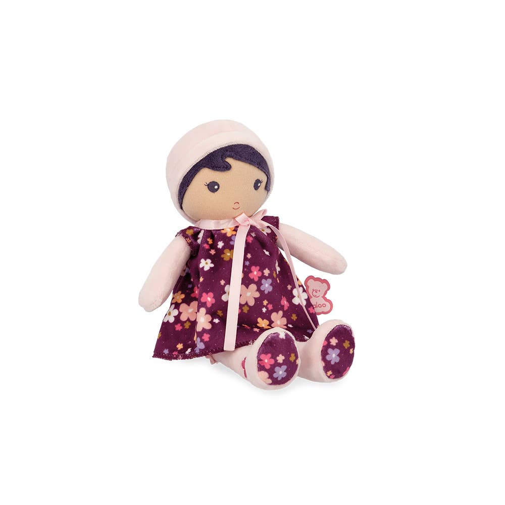 Stuffed doll with a floral dress on a white background