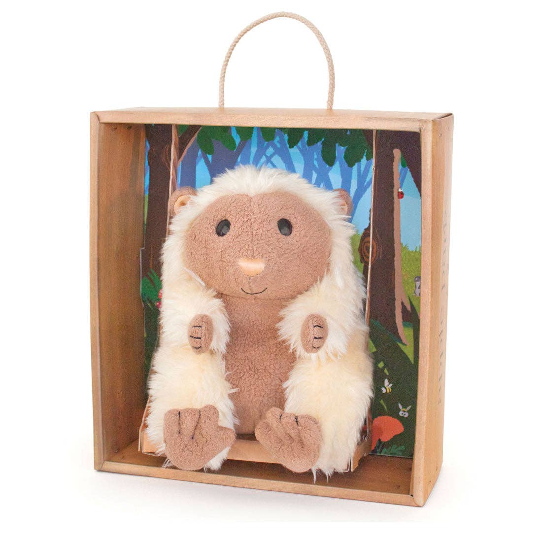 Plush porcupine  toy in a wooden gift box with a forest design on the inside.