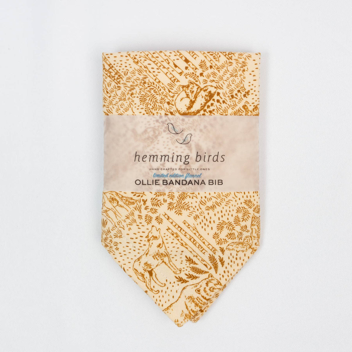 Packaged hemming birds Ollie Bandana Bib with floral pattern on a white background