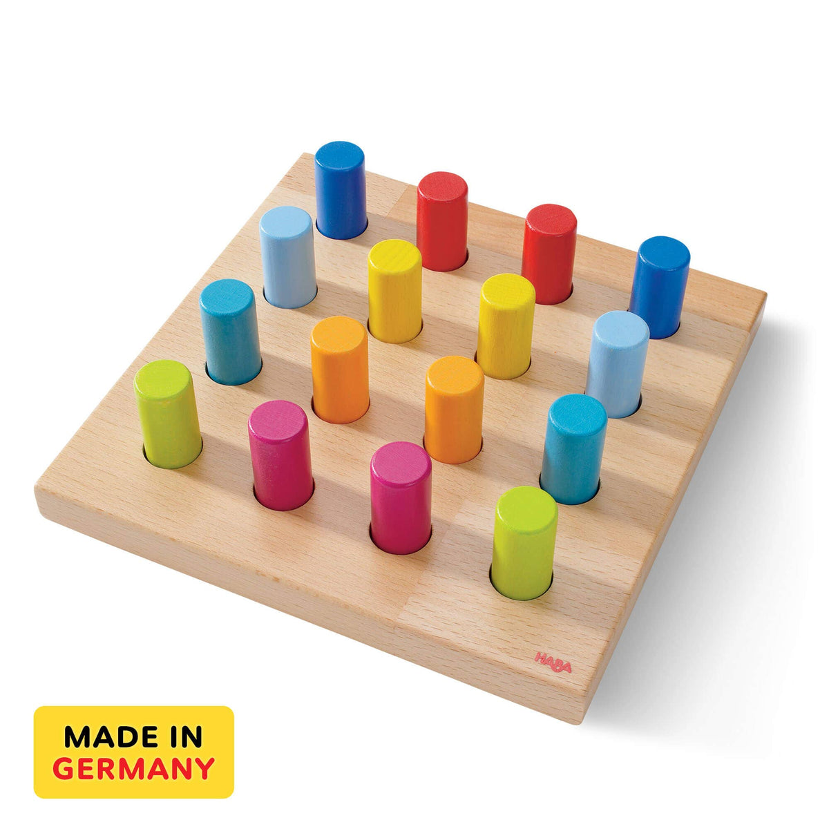 Colorful wooden cylindrical blocks on a wooden board with &#39;Made in Germany&#39; label.