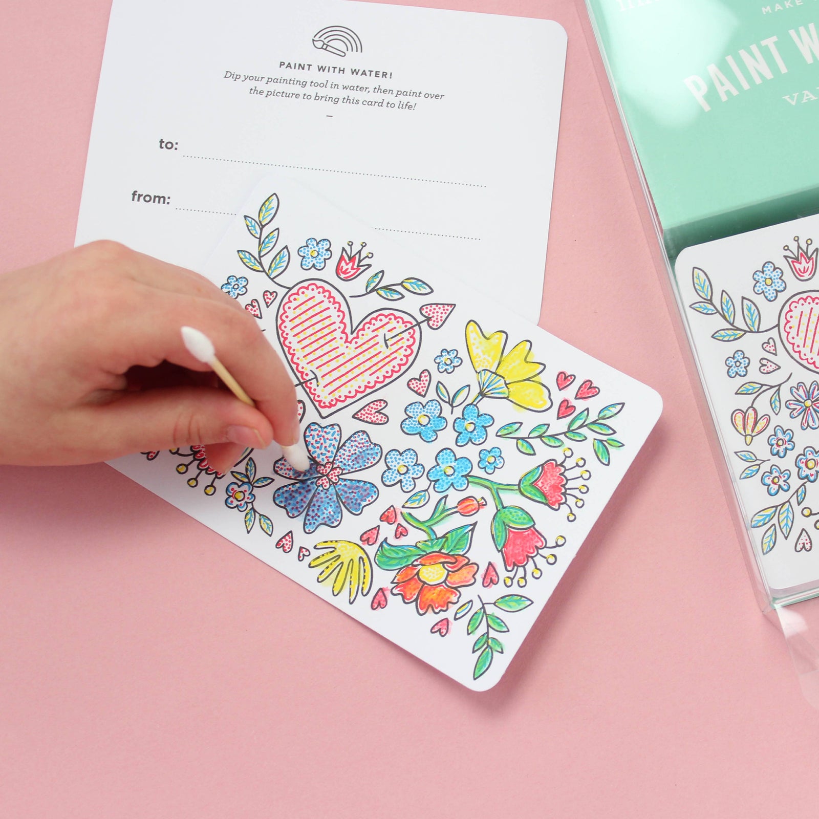 Pack of 'Paint with Water' Valentine cards with floral and heart designs on a white background.