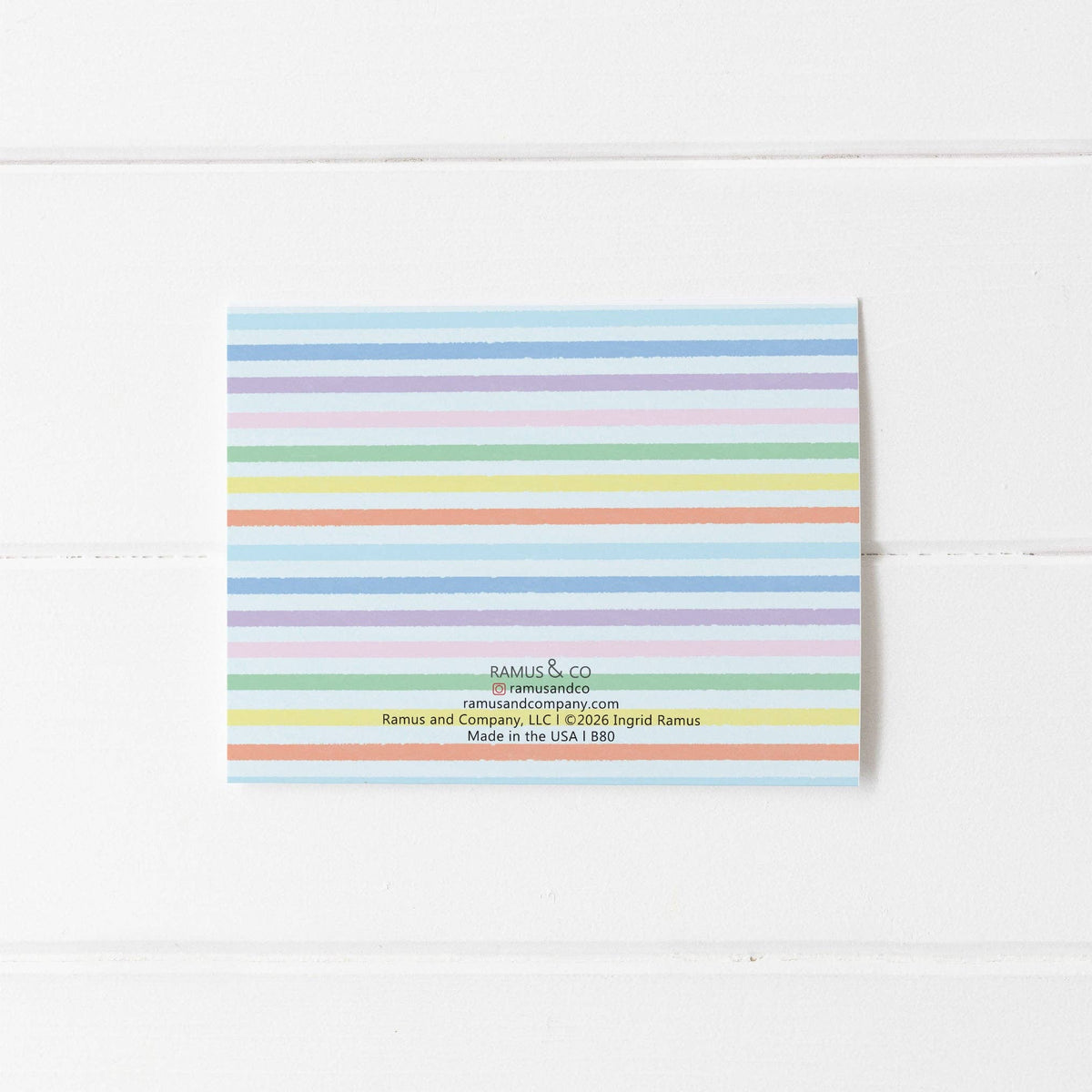 Colorful striped envelope with brand name on a white background