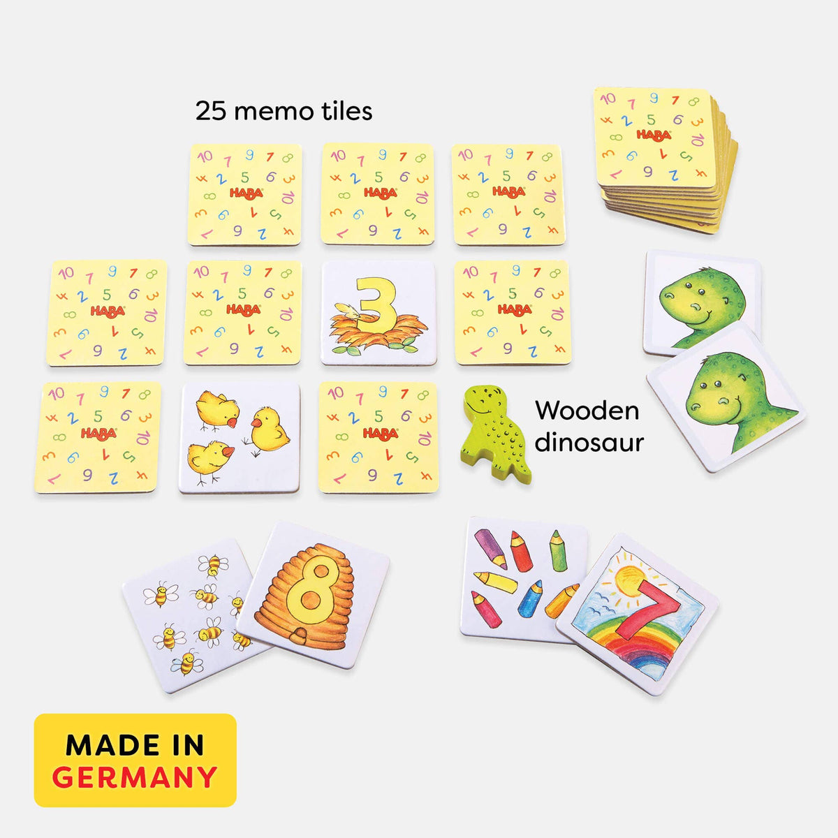Set of colorful memo tiles with numbers and animals, including a wooden dinosaur, on a white background.