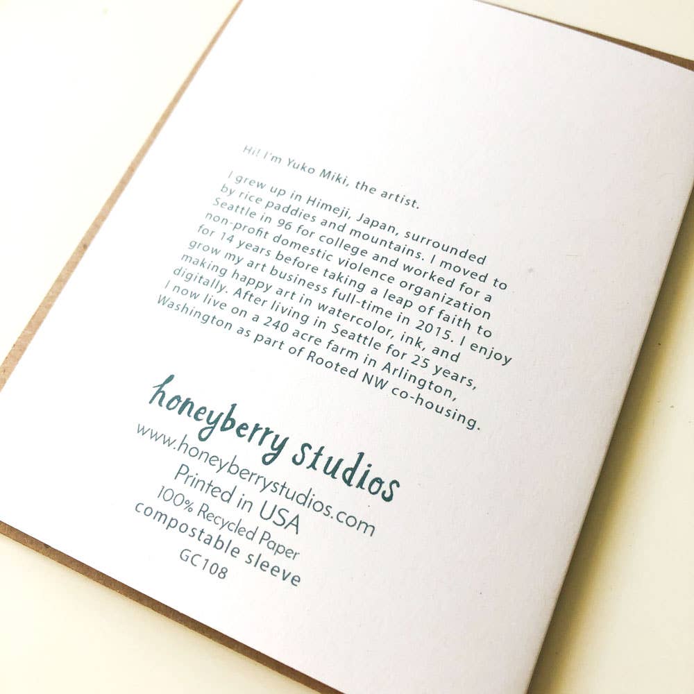 Book with text on recycled paper and compostable sleeve, featuring honeyberry studios branding.