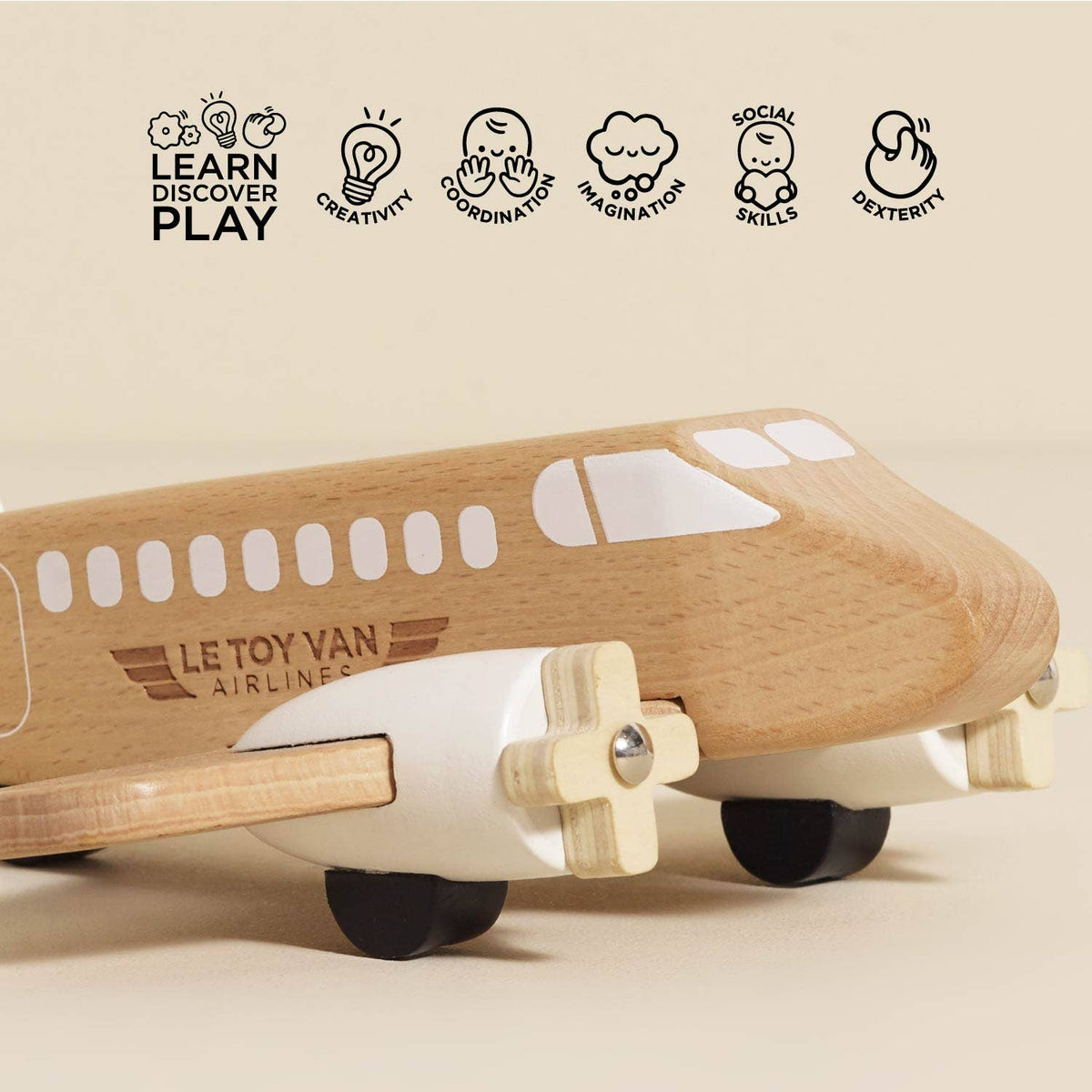 Wooden toy airplane with educational icons and text on a beige background