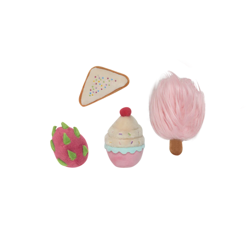Set of toy food items including bread, a cup, and a pink fruit on a patterned background