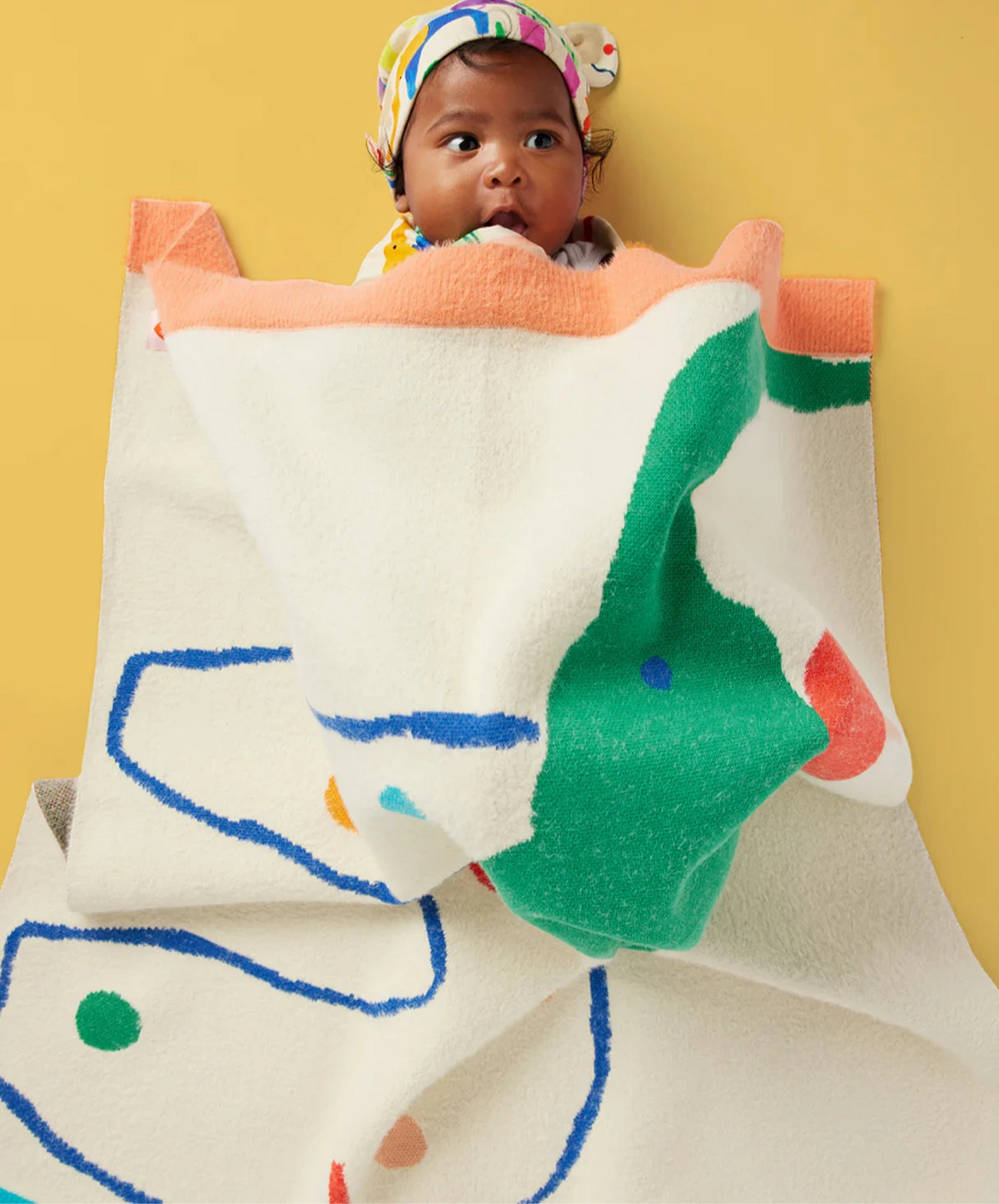 Baby wrapped in elephant print blanket