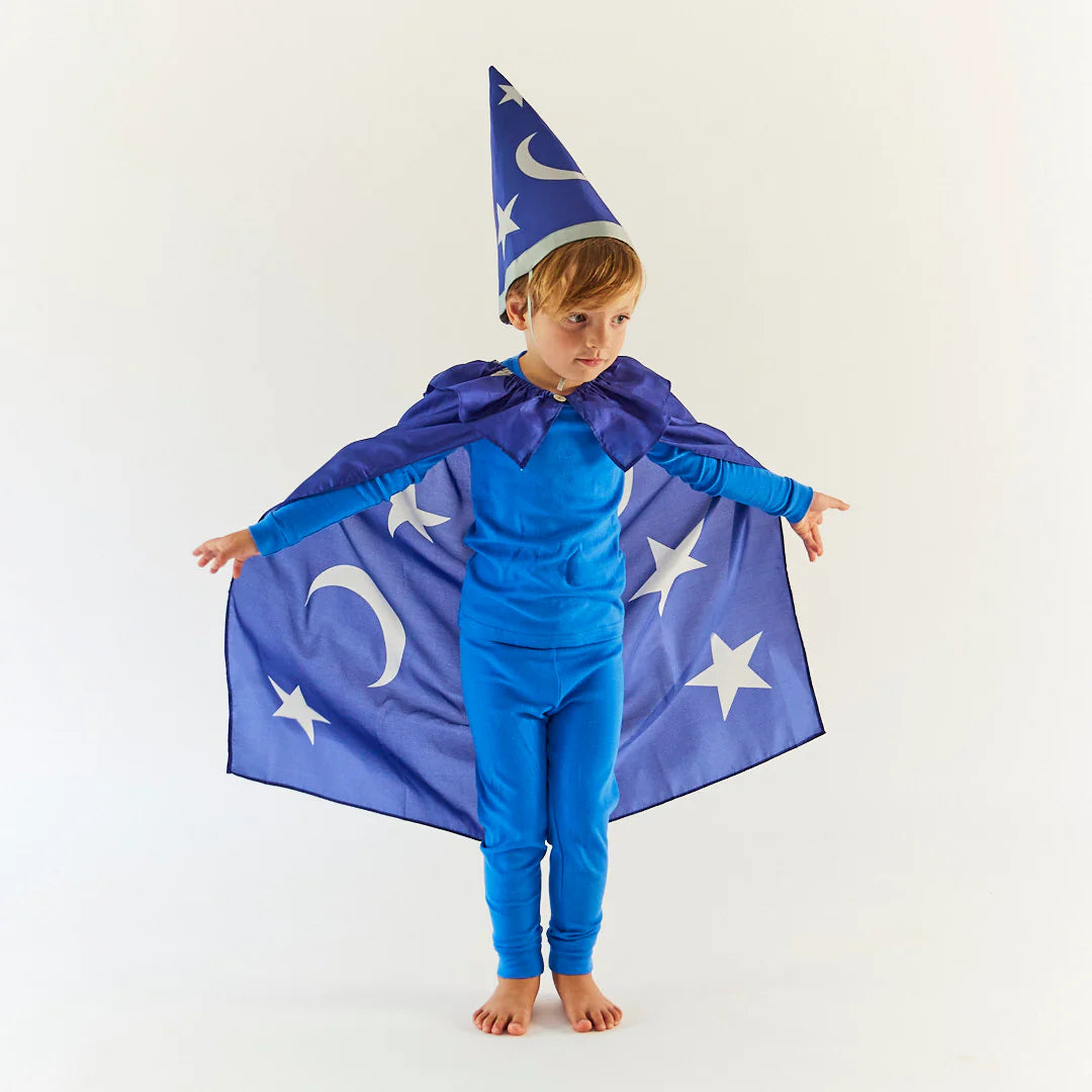 Child wearing a blue wizard costume with a cape and hat on a white background