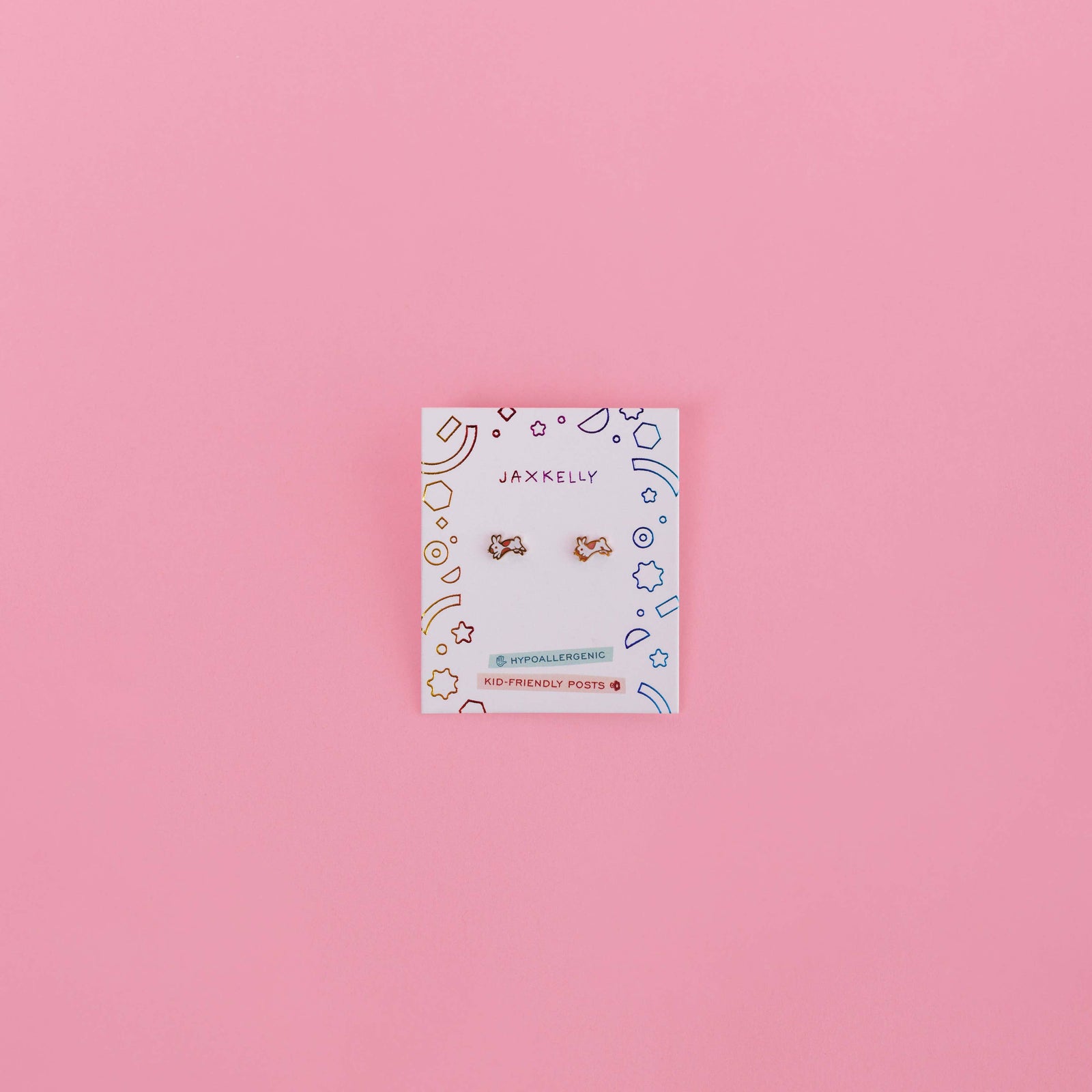 Jewelry card with earrings on a pink background