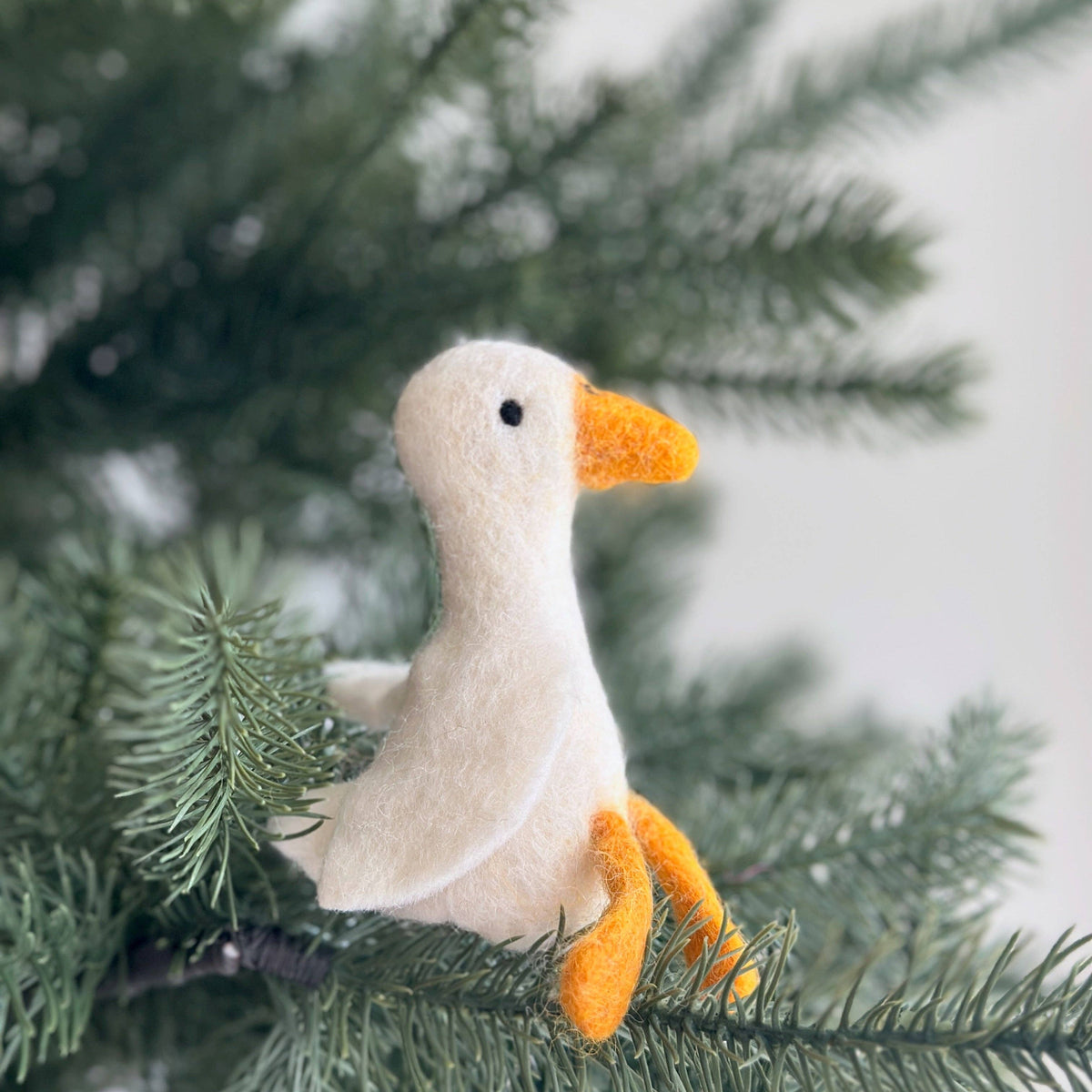 Felt goose ornament on a Christmas tree branch