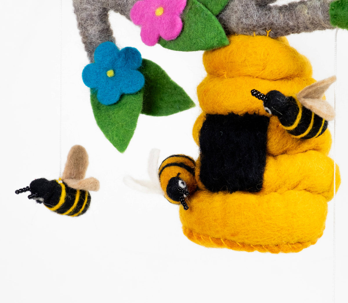 Felt bee and flowers on a white background