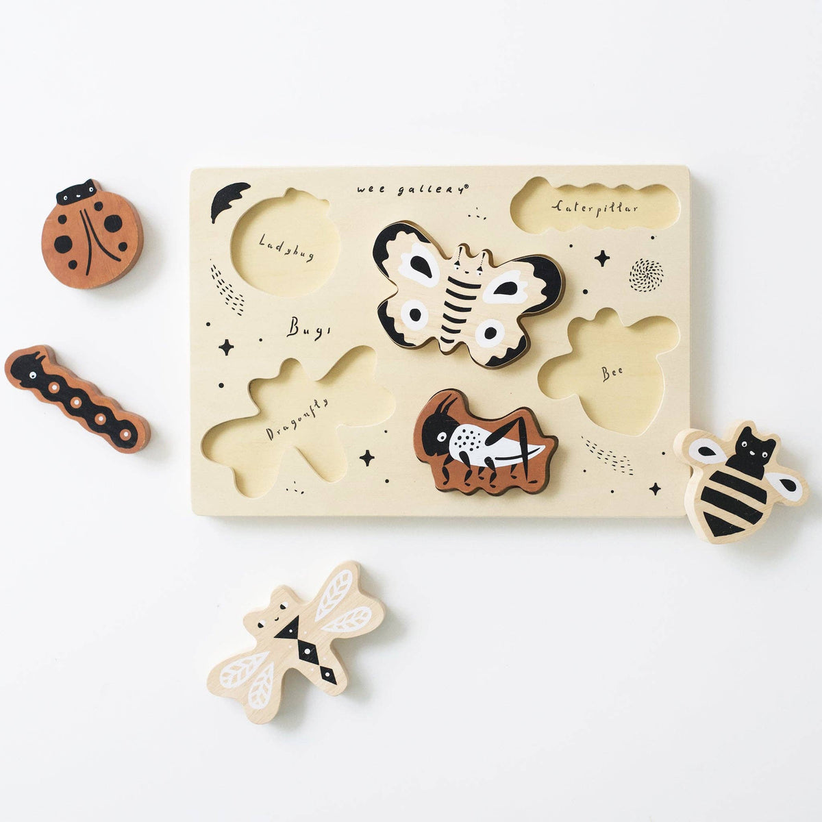 Wooden puzzle with bug shapes on a white background