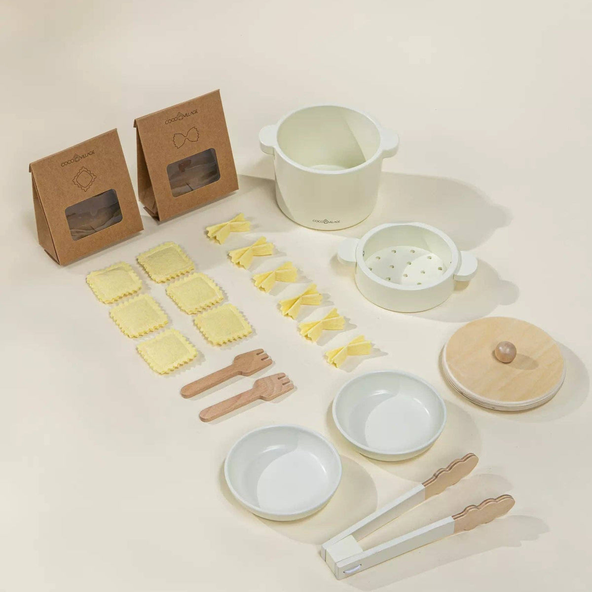 Set of wooden play kitchenware items including bowls, a pot, and utensils on a light background