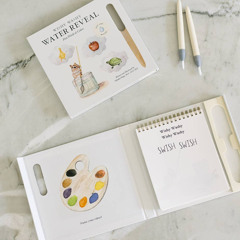 Wishy Washy water reveal book with pen on a beige background