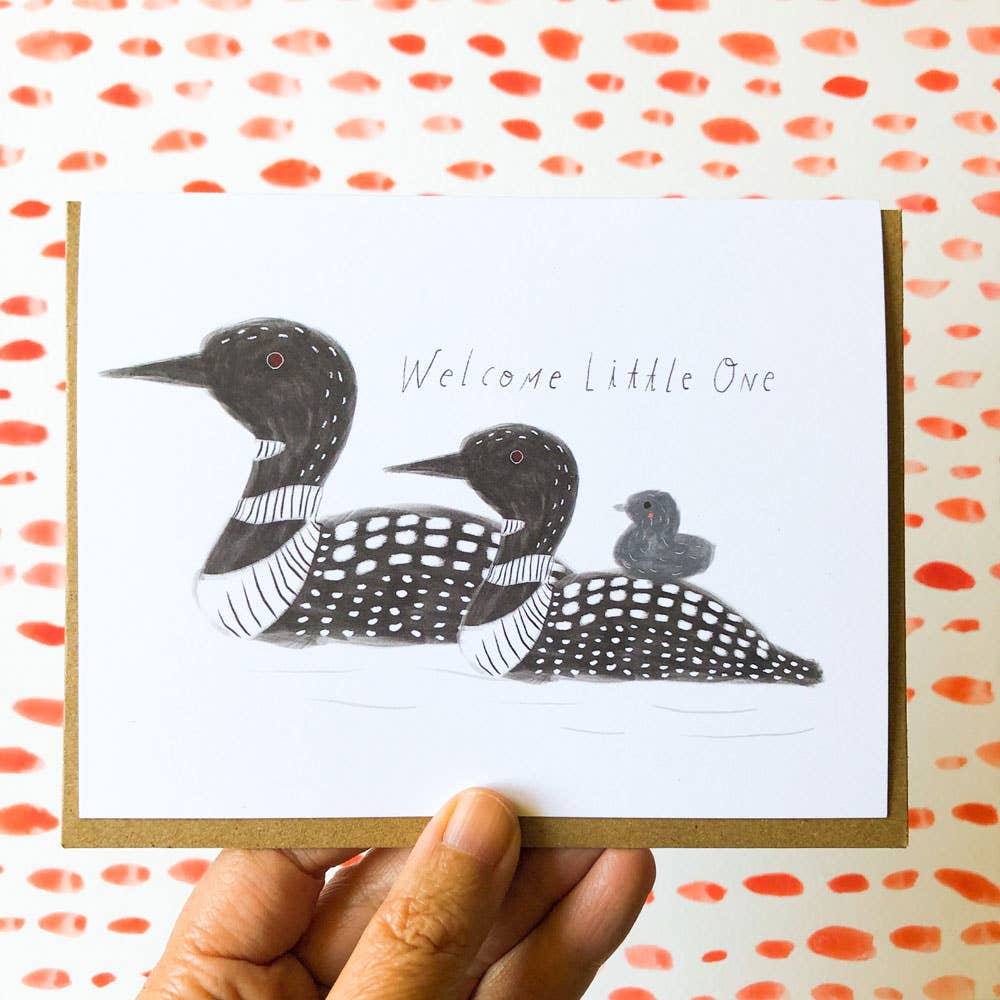 Greeting card with illustrations of loons and text 'Welcome little one' on a white background.