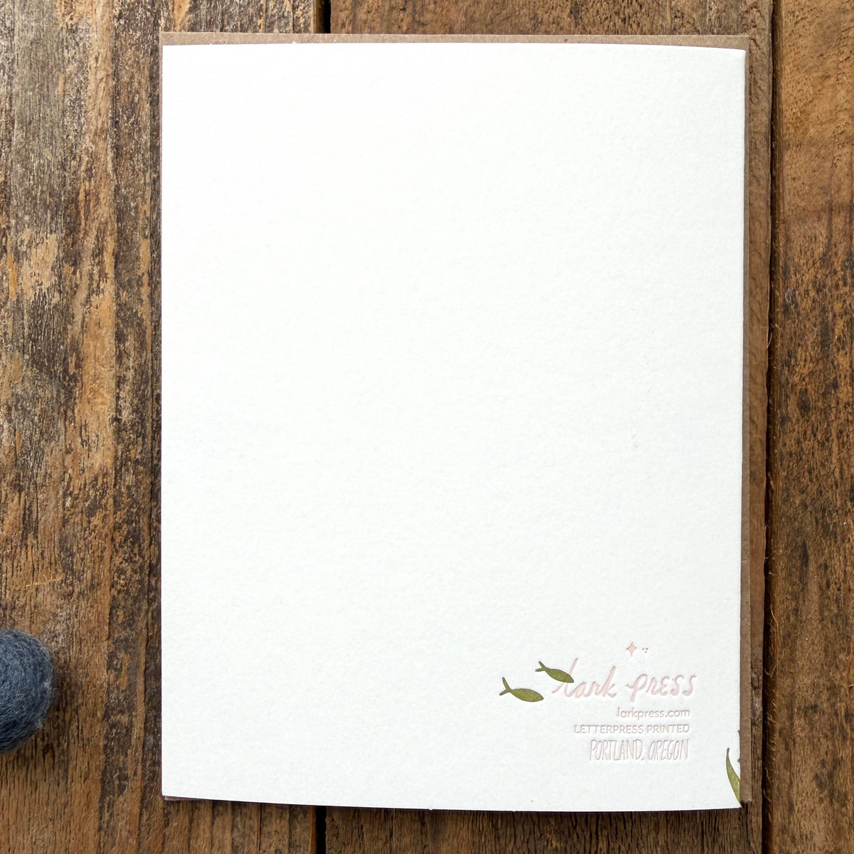 White paper with text and small illustrations on a wooden surface