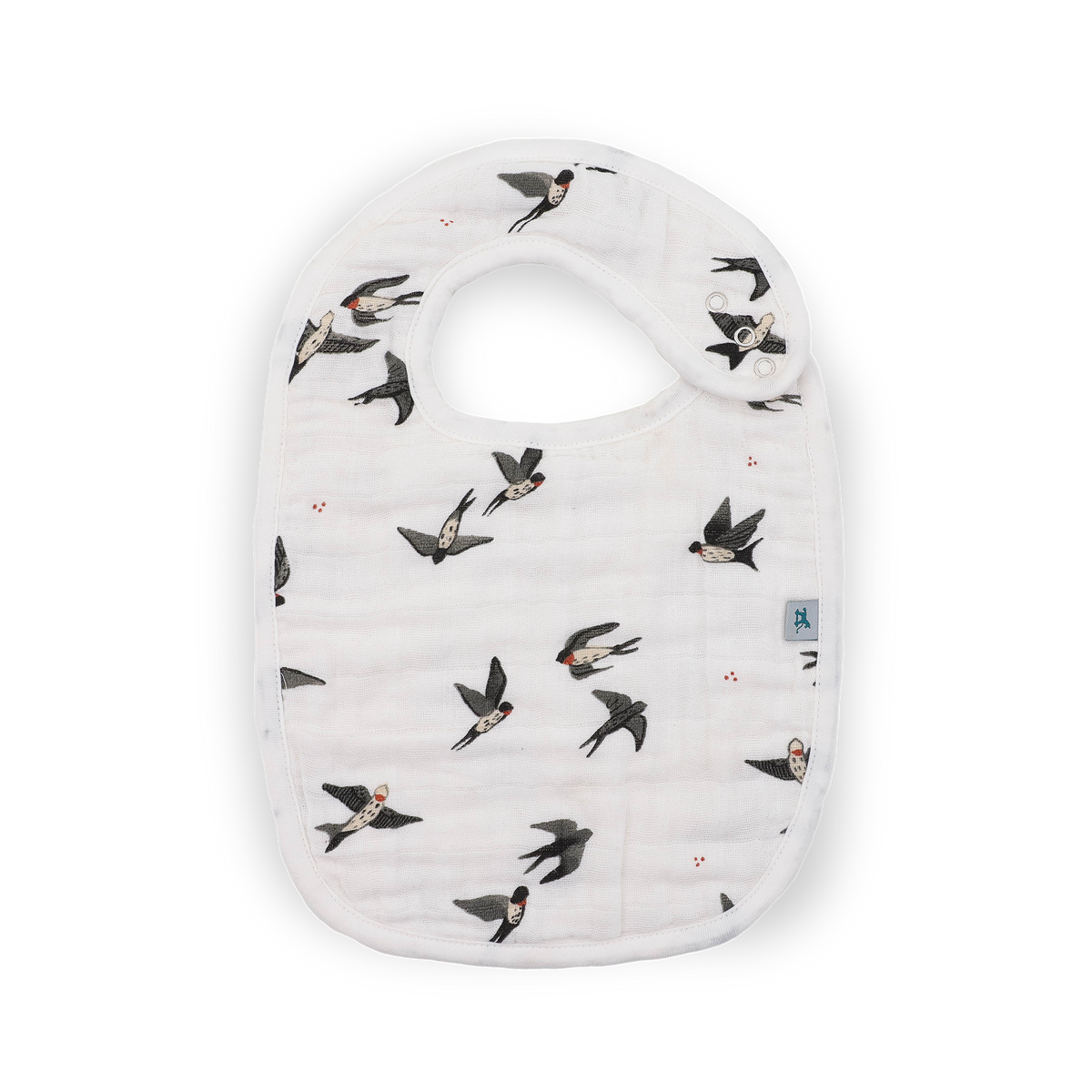 A white muslin baby bib with a pattern of flying swallows shown on a clean white background.