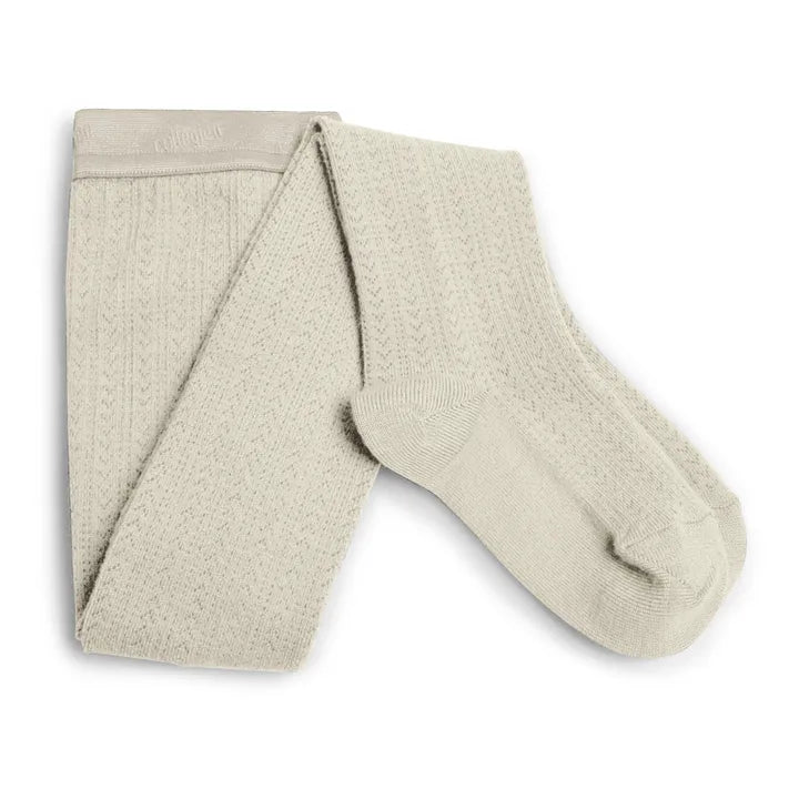 Pair of cream tights on a white background