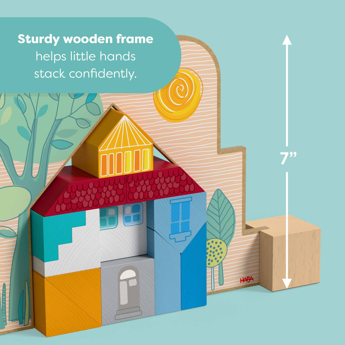 A colorful wooden house stacking toy set shown on a light blue background with a text callout and height measurement. The set includes a house-shaped wooden frame with painted sections in red, blue, yellow, white, and orange, plus separate wooden blocks.