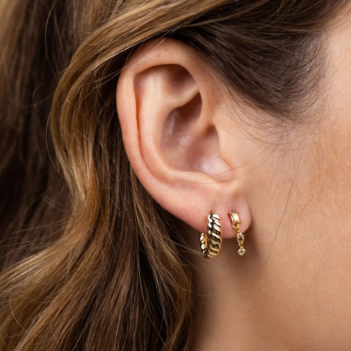 Gold hoop earrings on a white background