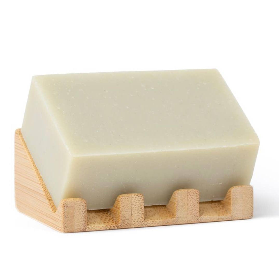 Pink exfoliating soap bar on a wooden stand with 'sunniemade' packaging in the background.