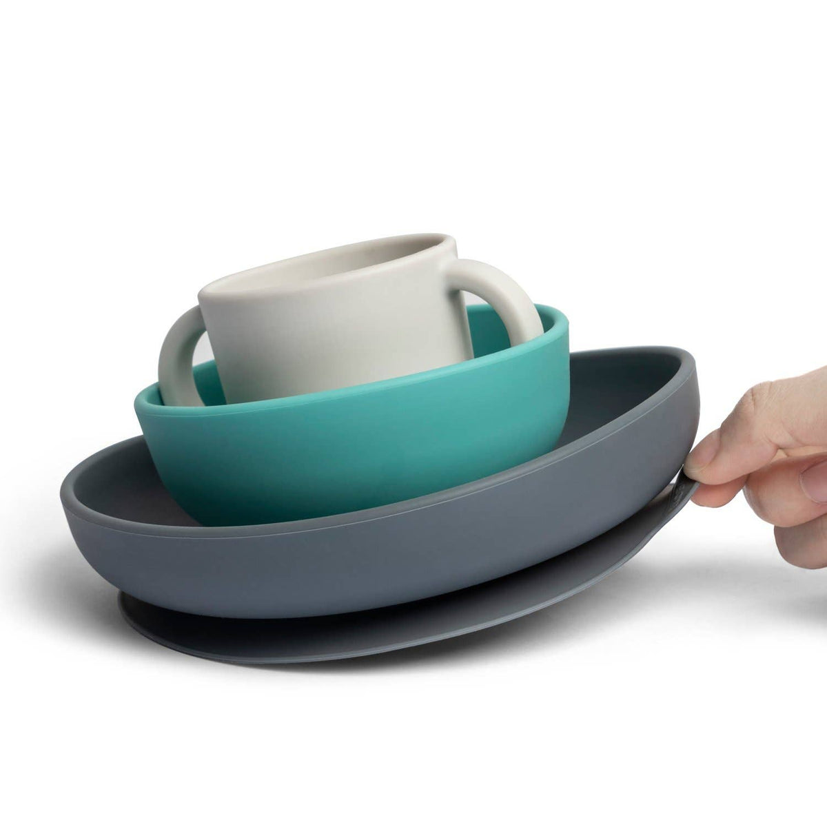 Set of silicone dishes including a mug, bowl, and plate on a white background