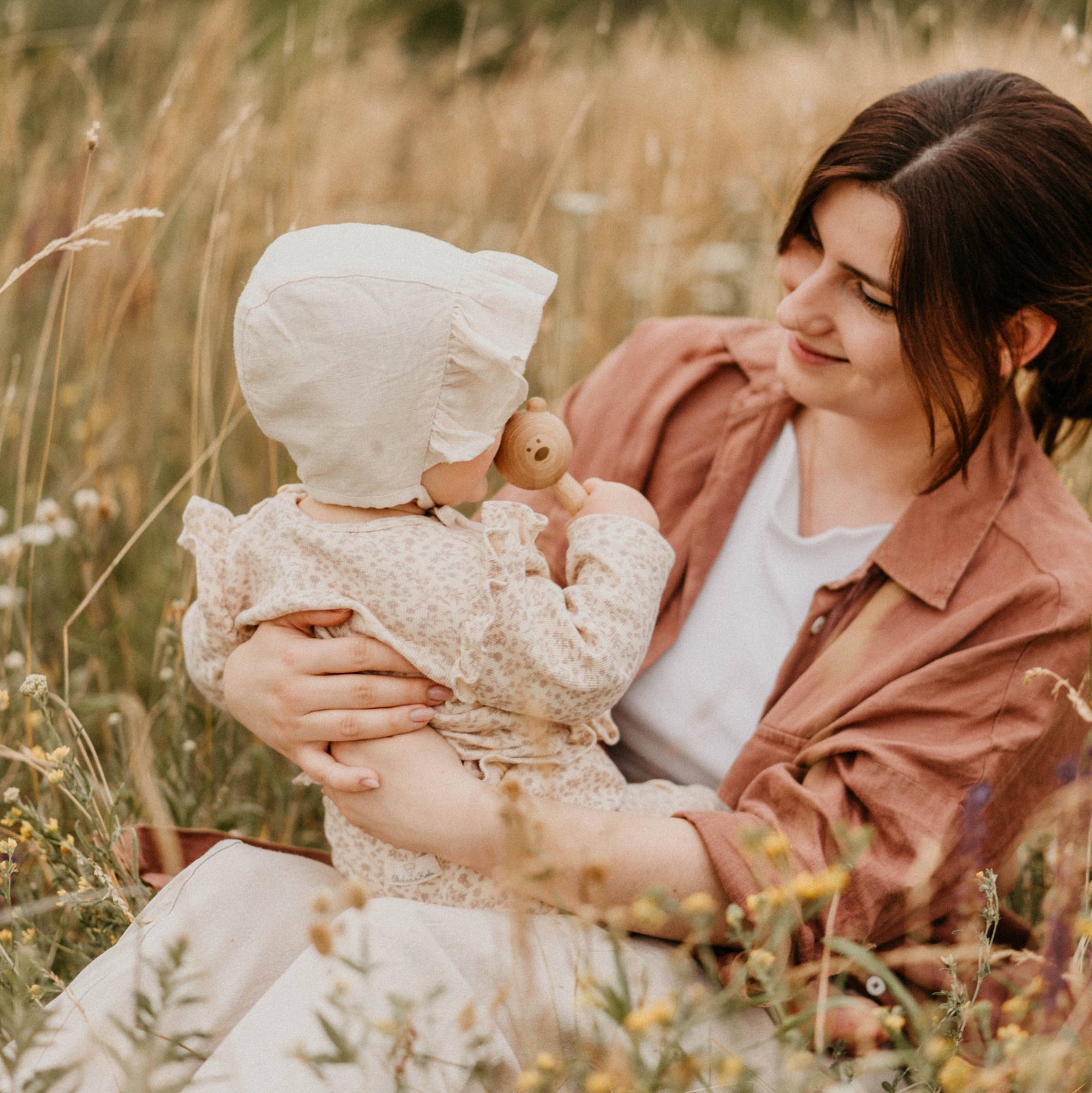 Wooden rattle with a bear handle on a white background