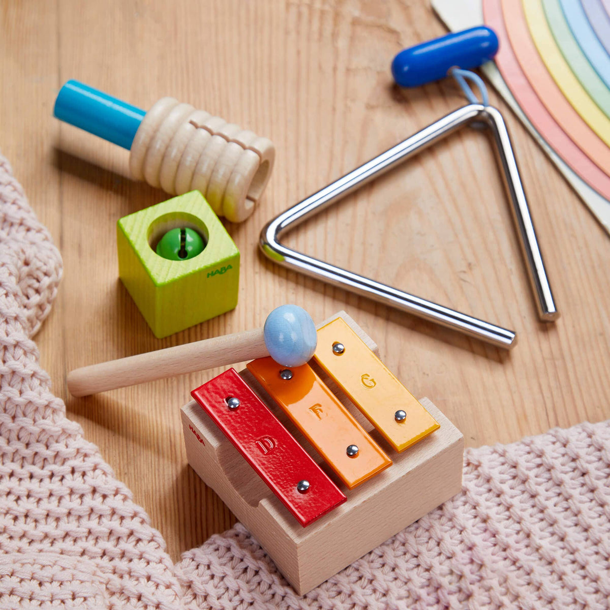 Set of colorful children&#39;s musical instruments on a wooden surface