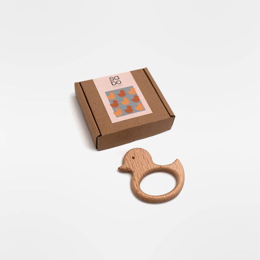 Wooden duck-shaped teething ring on a white background
