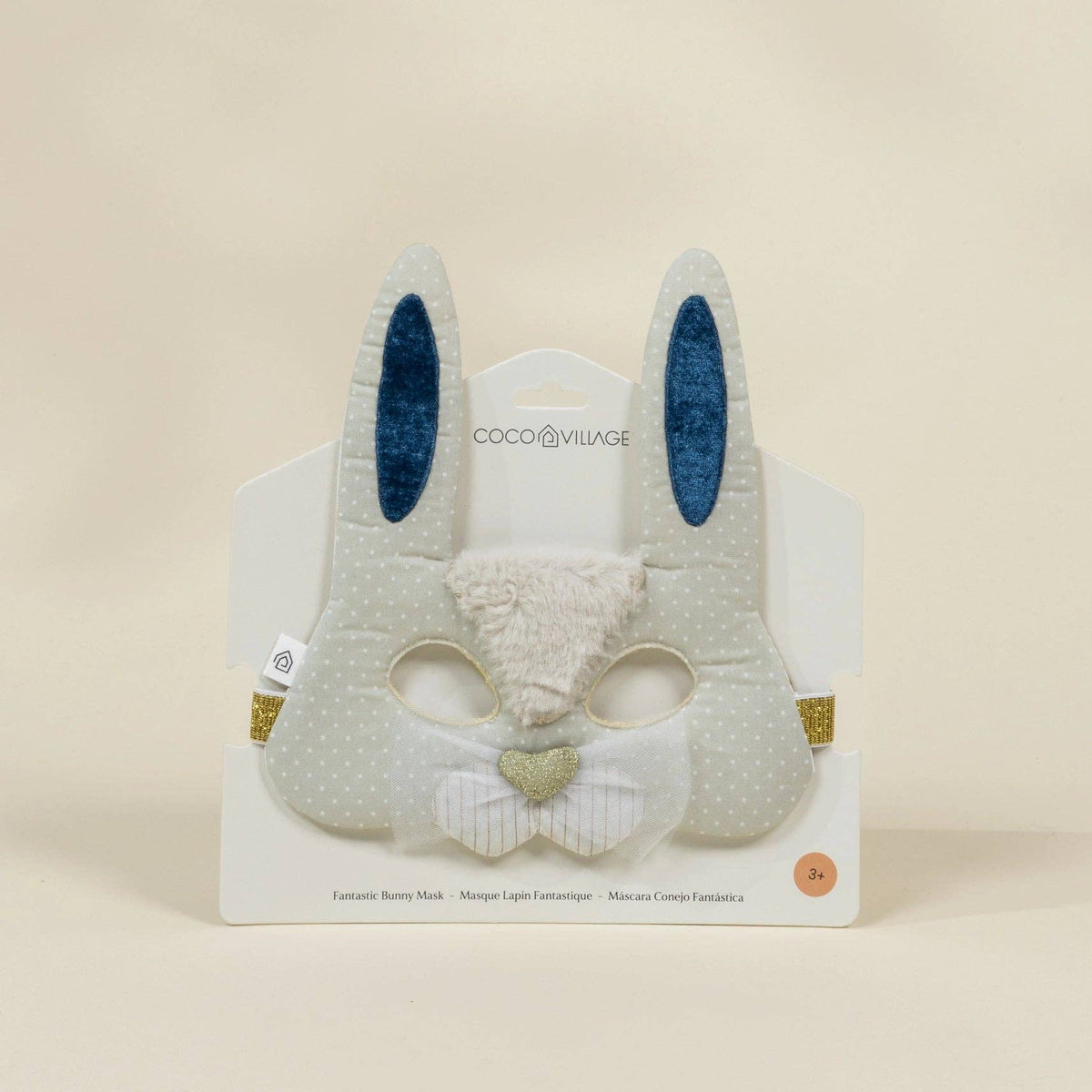 Plush bunny mask with blue ears on a beige background
