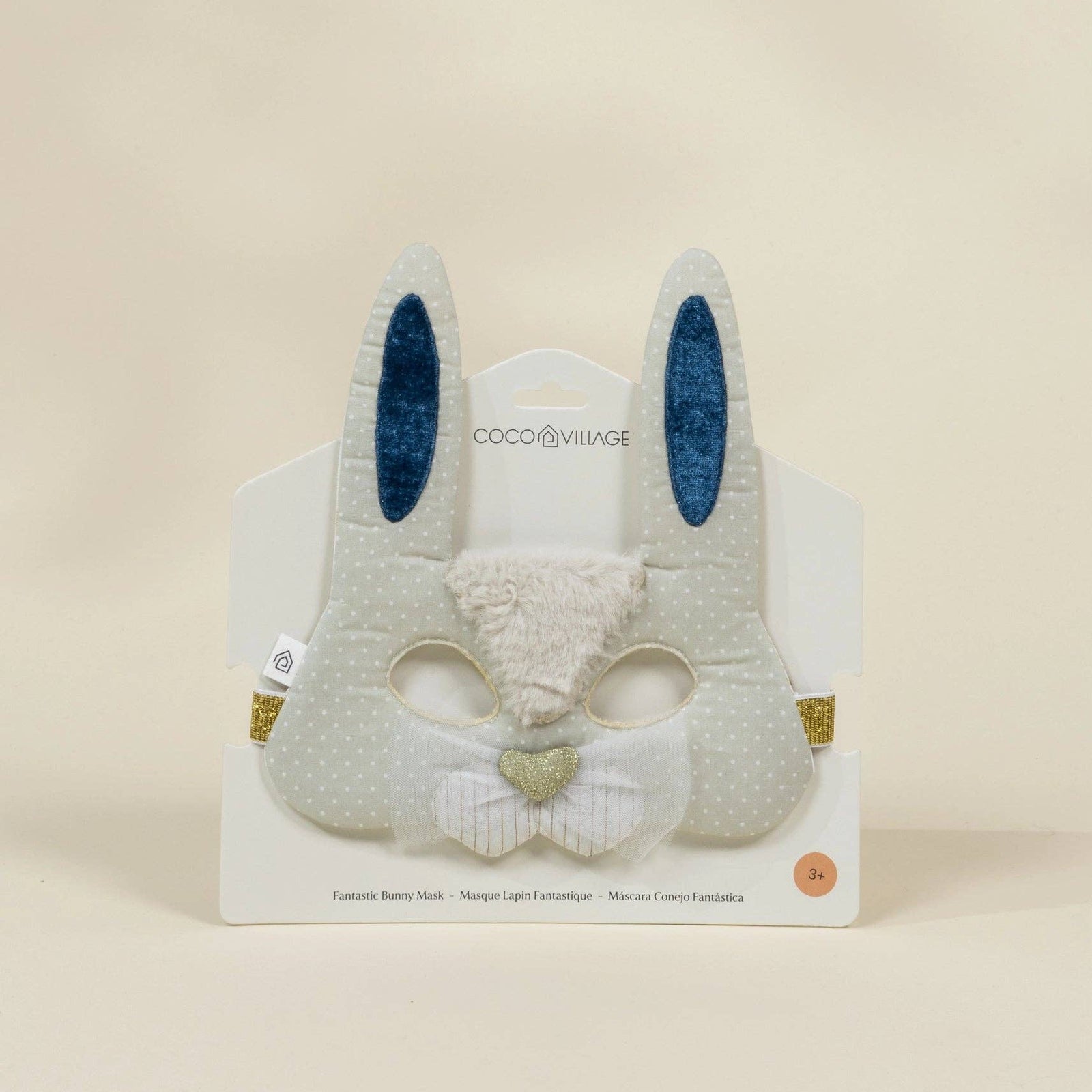 Plush bunny mask with blue ears on a beige background