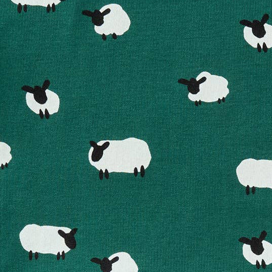 A close-up of a fabric pattern featuring white sheep with black faces and legs on a dark teal green background.