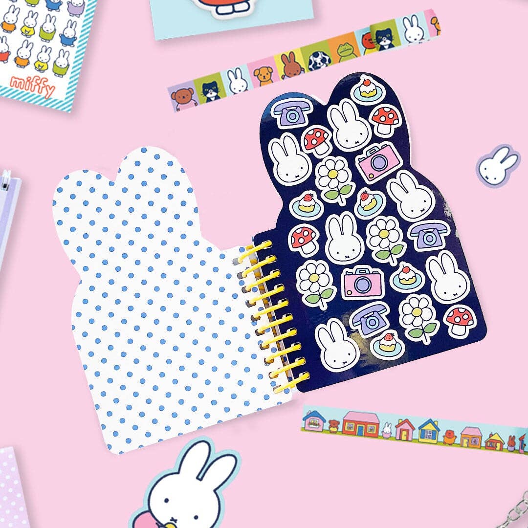 Notebook with a cartoon character on a blue polka dot cover against a white background