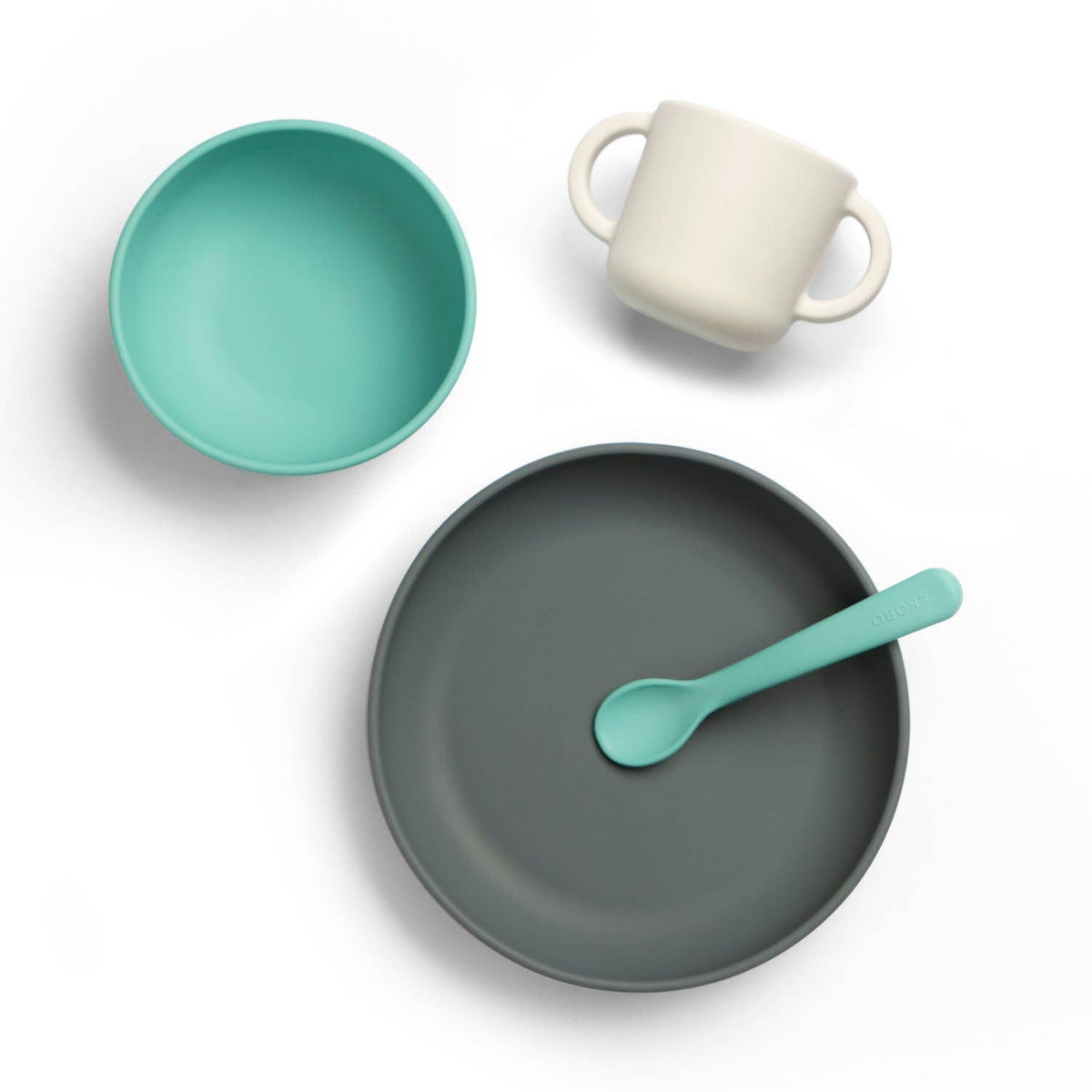 Set of ceramic tableware including a bowl, mug, plate, and spoon on a white background
