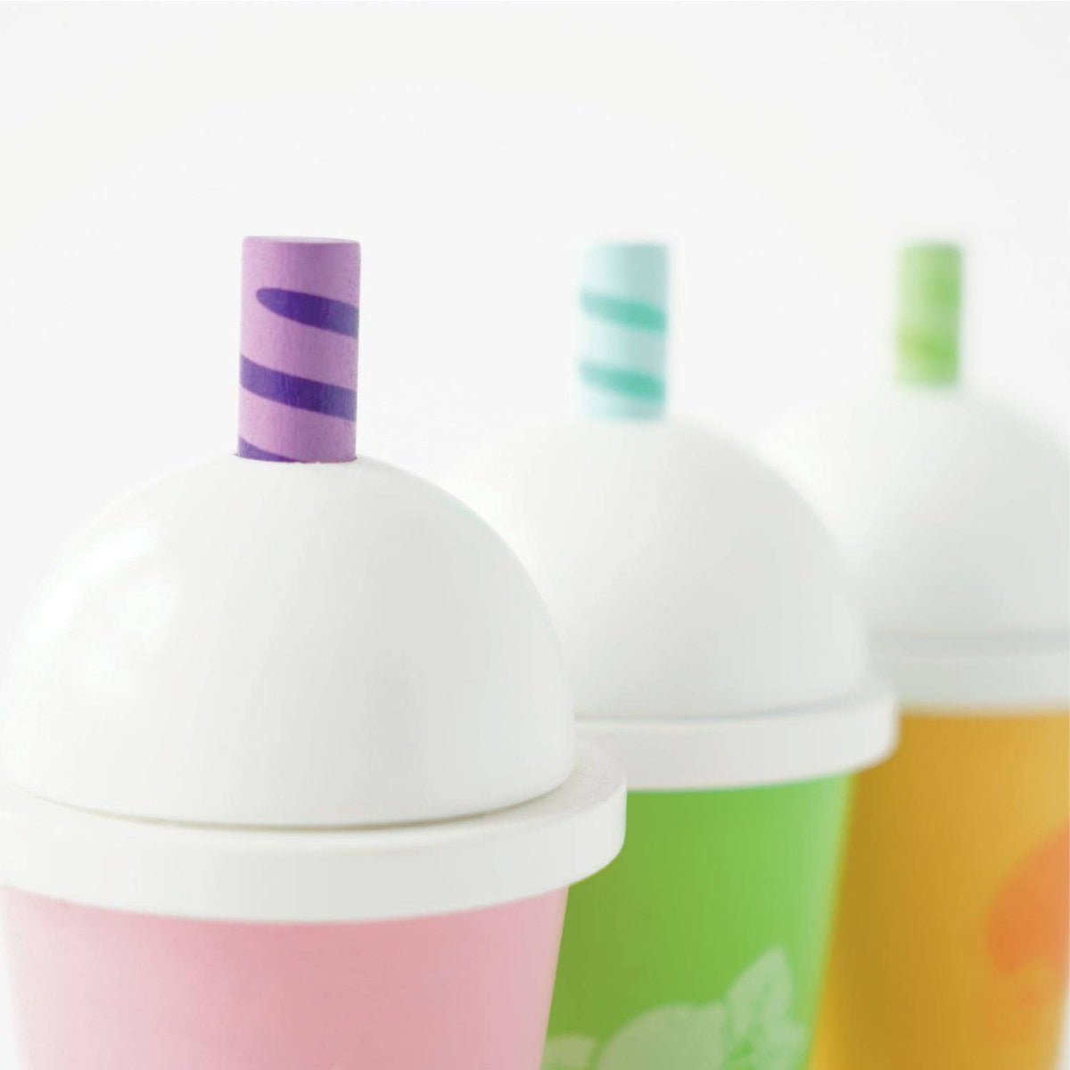 Colorful cups with lids and straws on a white background