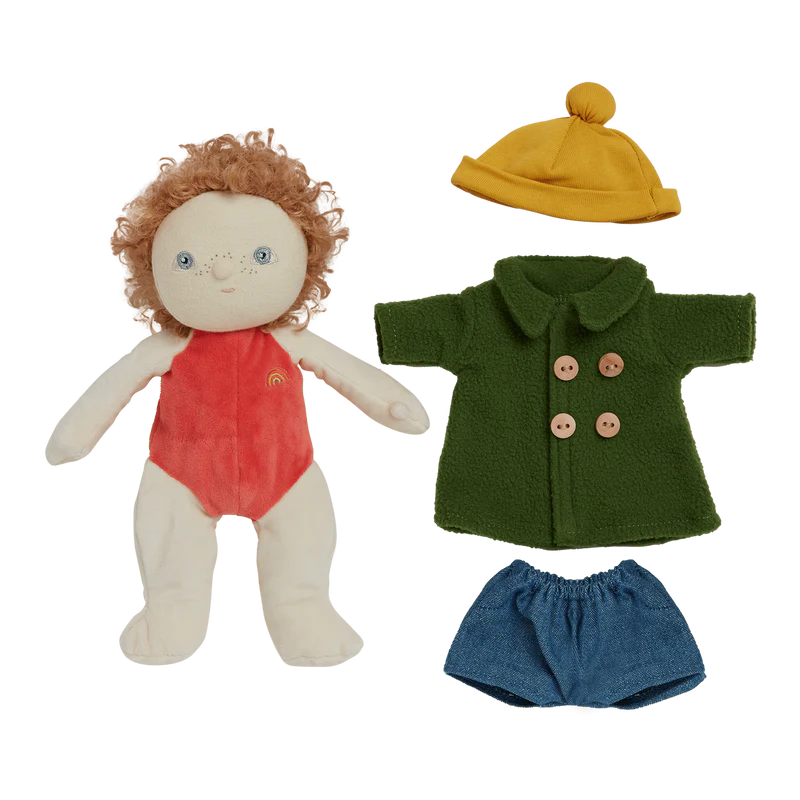 Doll with red outfit and accessories including a yellow hat, green coat, and blue shorts on a white background.
