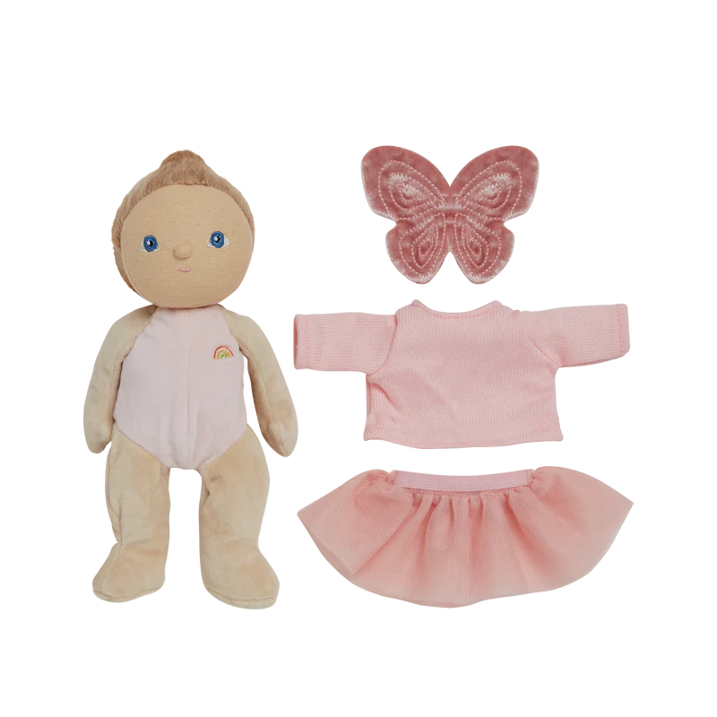 Toy baby doll in a pink outfit with a matching box on a pink background