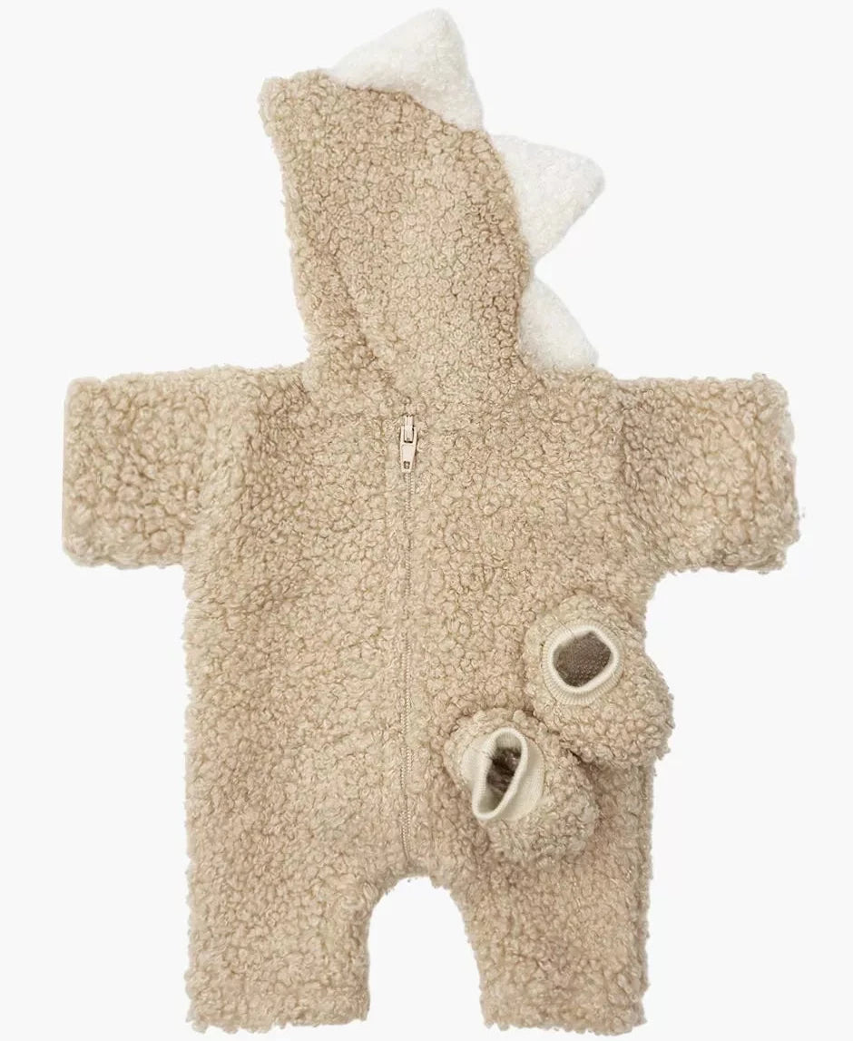 Beige baby onesie with white accents on a white background