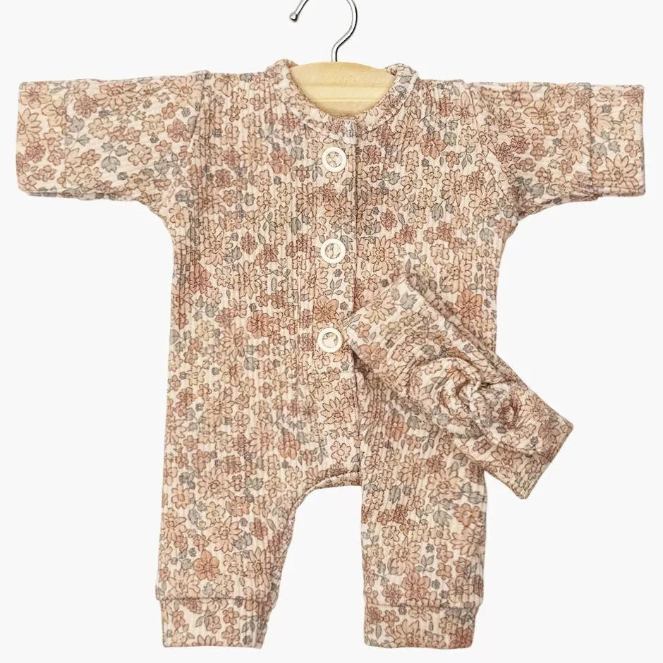 Floral-patterned baby romper on a hanger against a white background