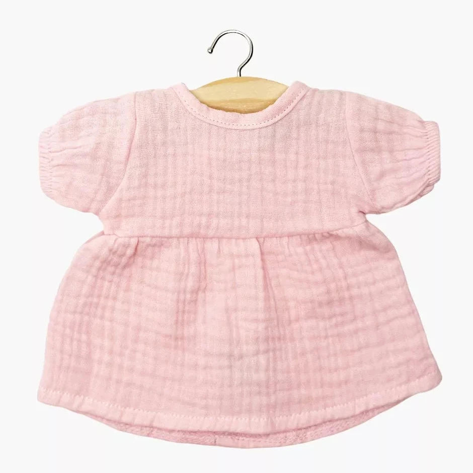 Pink baby  doll dress on a hanger against a white background
