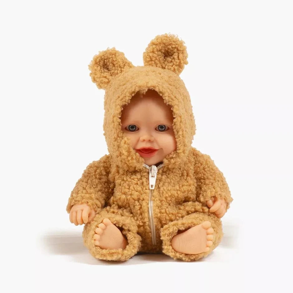 Baby doll wearing a brown bear onesie on a white background