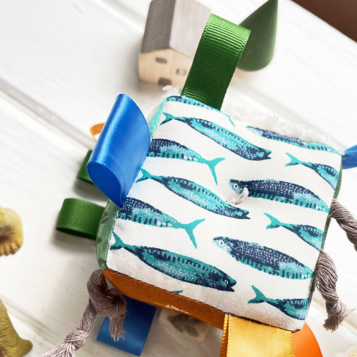 Children's toy with whale patterned cushion on a white surface