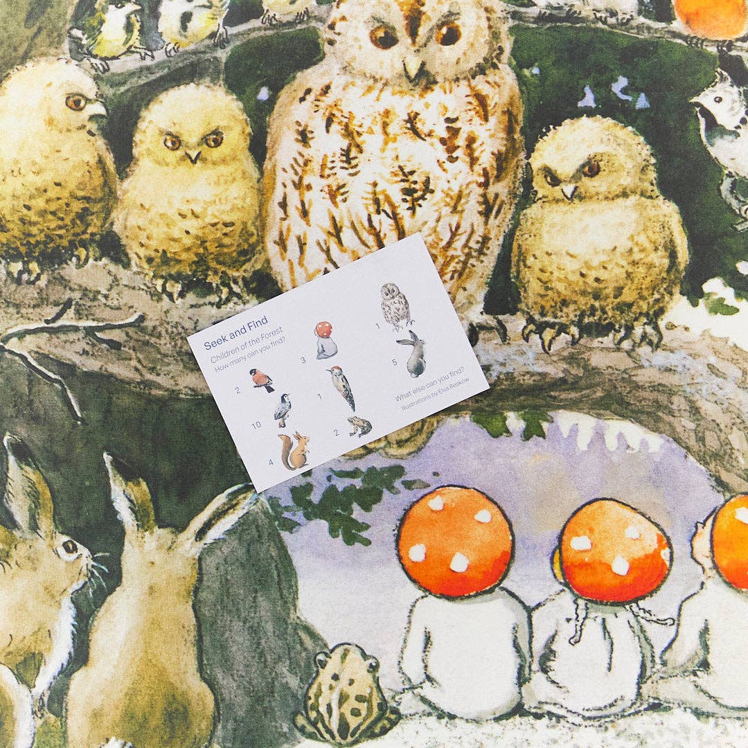 A close-up of a printed fabric pattern featuring a woodland scene with several owls, a rabbit, mushrooms, and a small card labeled 'Beak and Feed' placed on top.