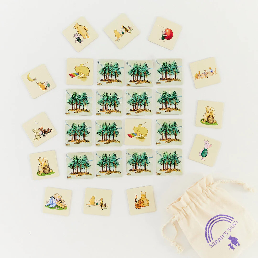 Collection of illustrated cards featuring nature scenes and animals on a white surface with a drawstring bag.