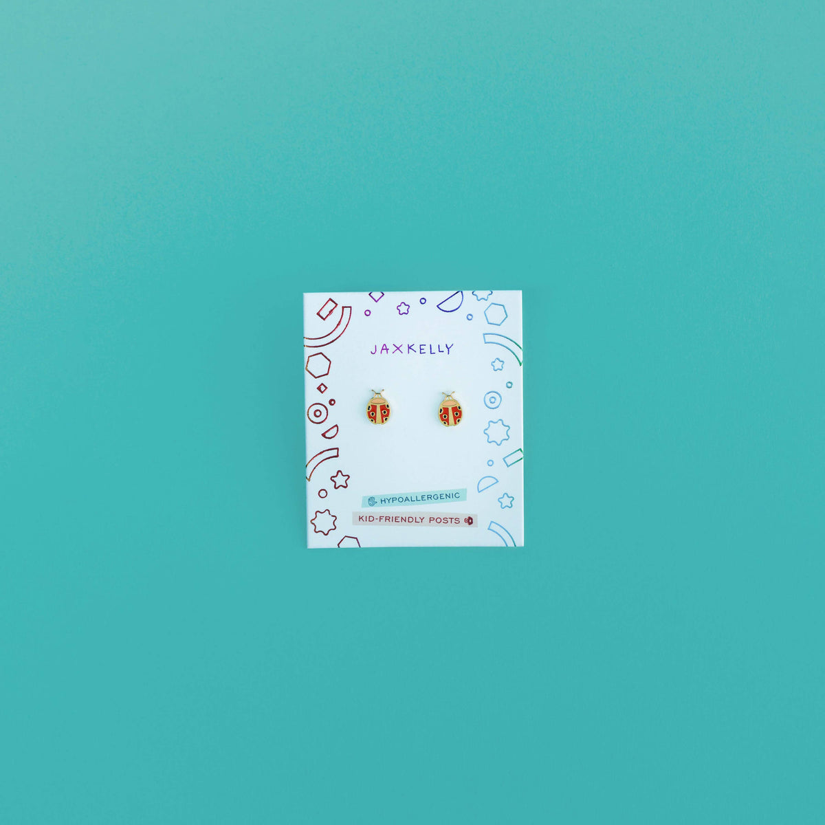 Earrings packaging on a teal background