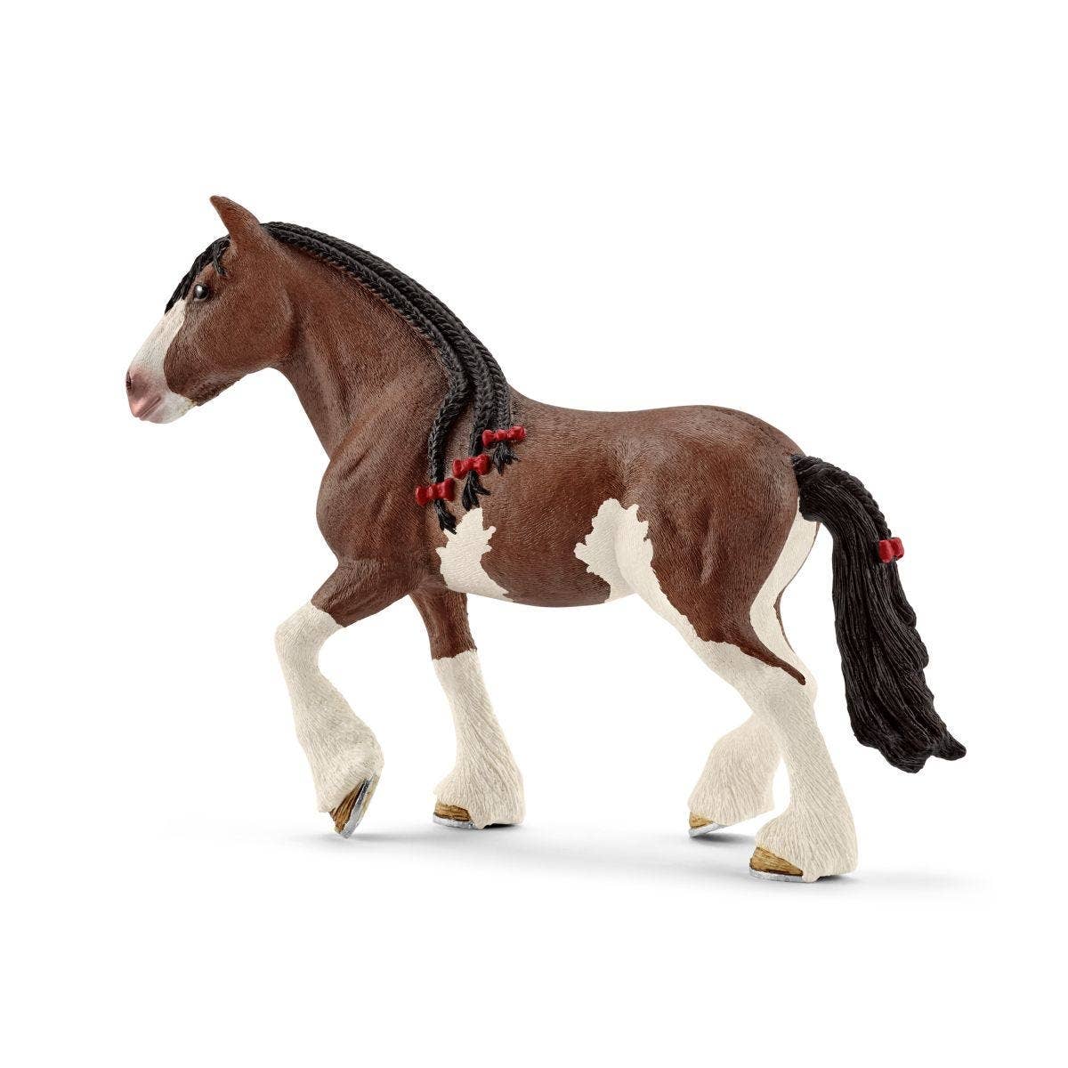 Model horse with a braided mane on a white background