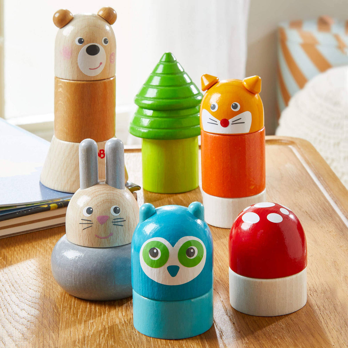 Set of colorful wooden toys shaped like animals on a wooden surface.
