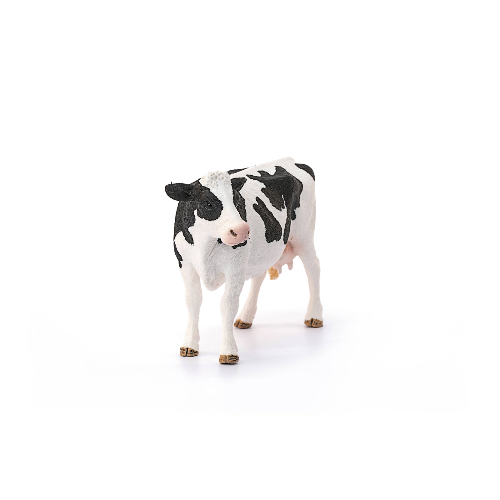 Model of a cow with black and white pattern on a white background