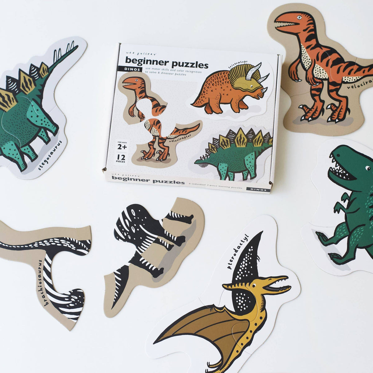 Dinosaur-themed beginner puzzles with packaging on a white background